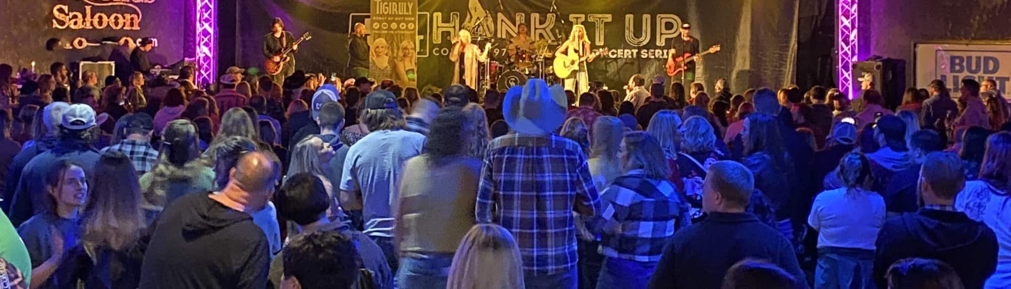 country concert with fans wearing cowboy hats Madison